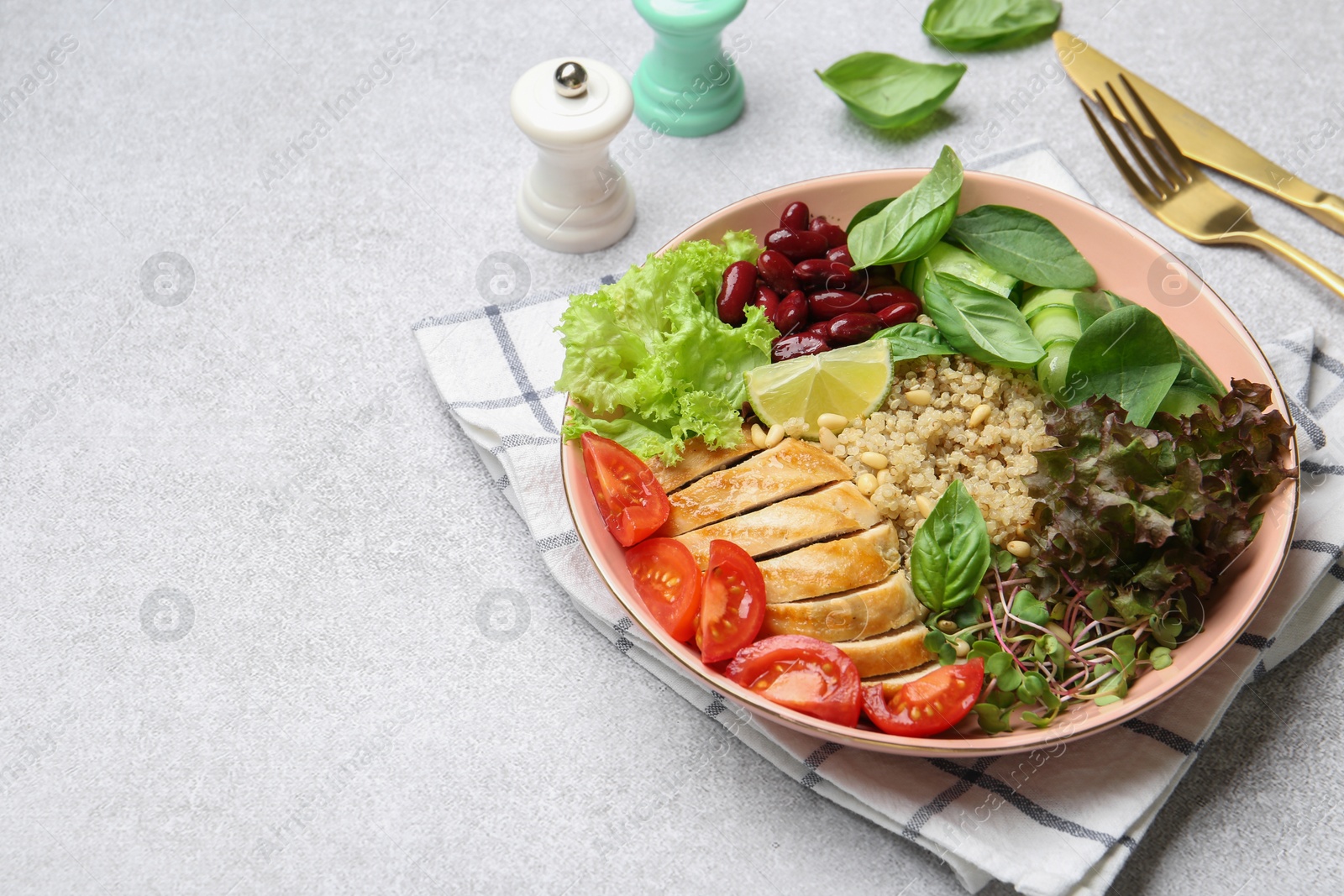 Photo of Healthy meal. Tasty vegetables, quinoa and chicken breast in bowl on white table, space for text