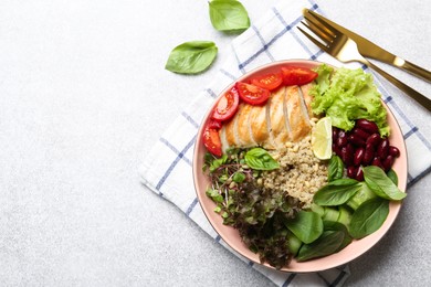 Photo of Healthy meal. Tasty vegetables, quinoa and chicken breast in bowl on white table, flat lay. Space for text