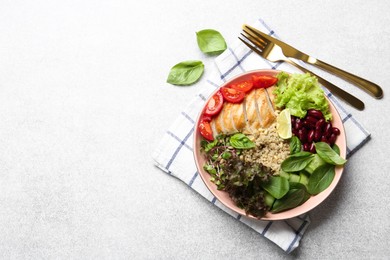 Photo of Healthy meal. Tasty vegetables, quinoa and chicken breast in bowl on white table, flat lay. Space for text