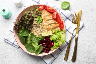 Photo of Healthy meal. Tasty vegetables, quinoa and chicken breast in bowl on white table, flat lay