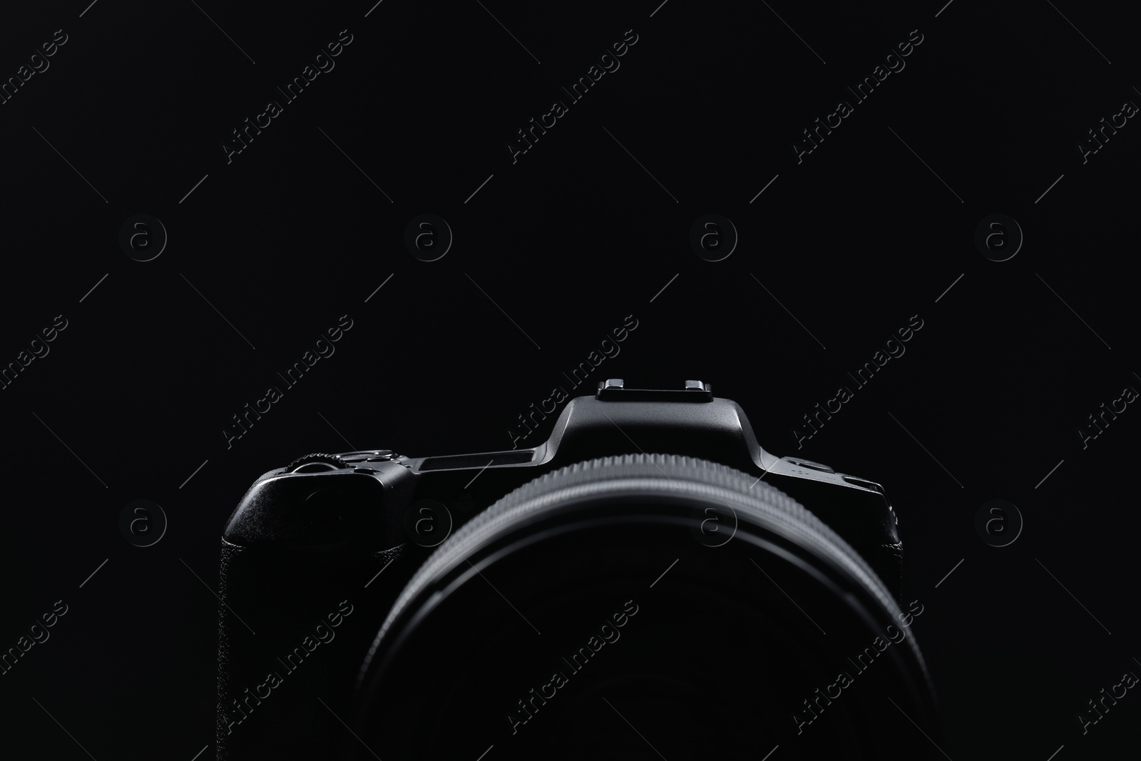 Photo of Modern photo camera on black background, closeup. Space for text