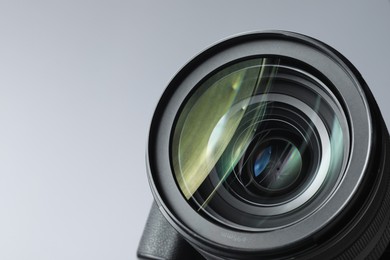 Modern camera lens on white background, closeup. Space for text