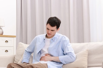 Photo of Man suffering from abdominal pain at home