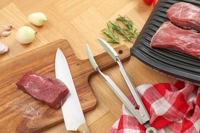 Photo of Electric grill and different products on wooden table, above view