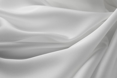 Texture of crumpled white silk fabric as background, closeup