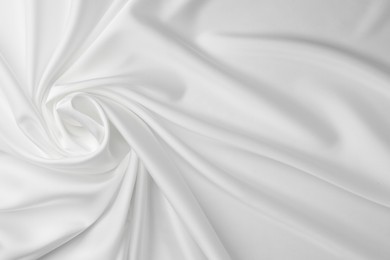 Texture of crumpled white silk fabric as background, top view