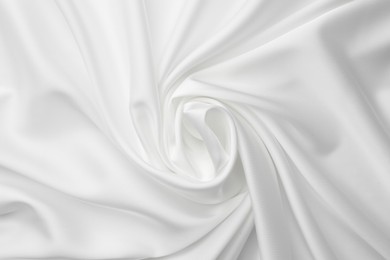 Photo of Texture of crumpled white silk fabric as background, top view