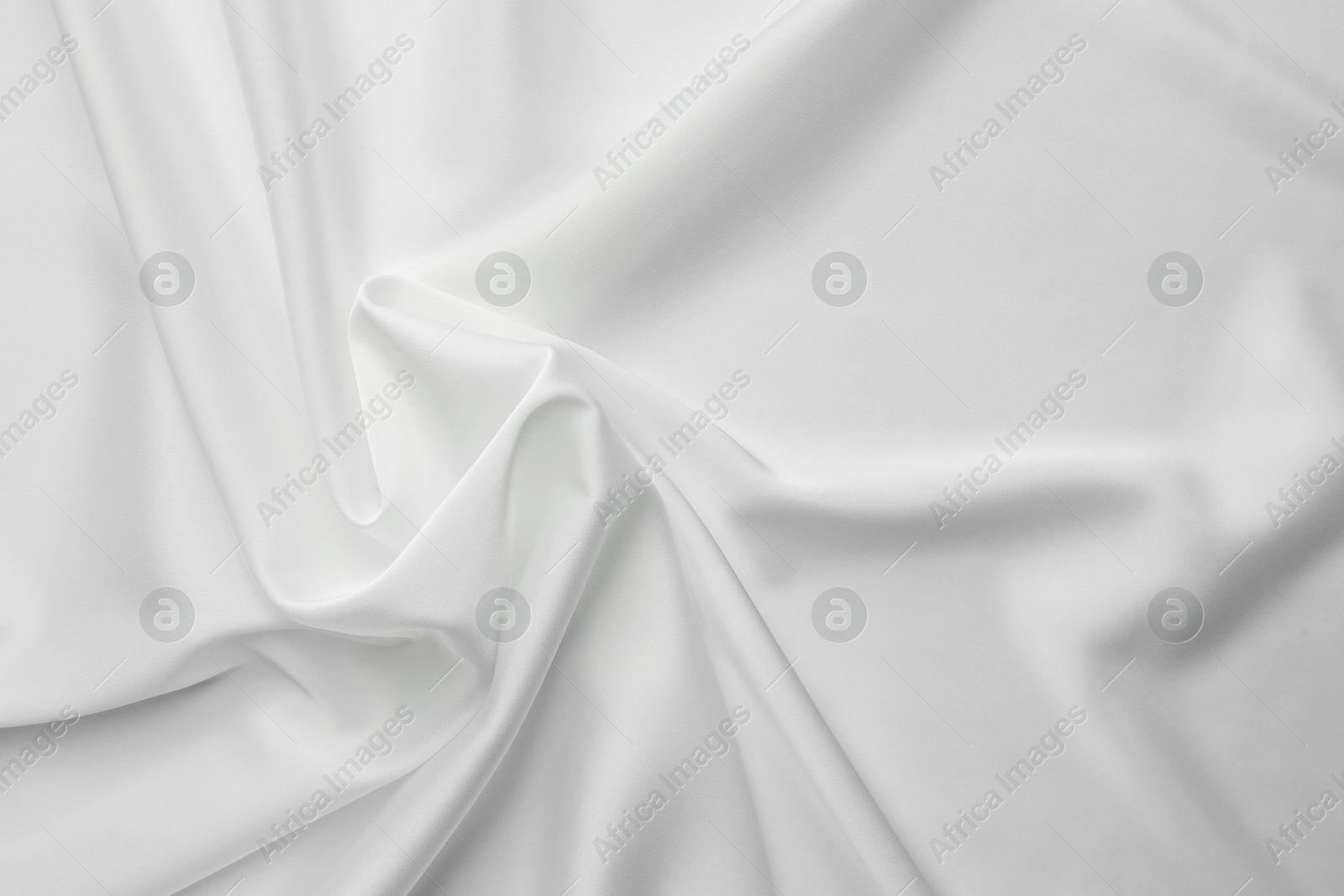 Photo of Texture of crumpled white silk fabric as background, top view