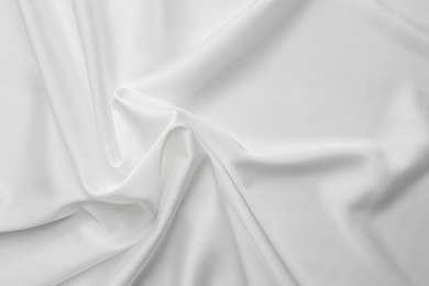 Texture of crumpled white silk fabric as background, top view