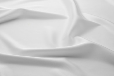 Photo of Texture of crumpled white silk fabric as background, closeup