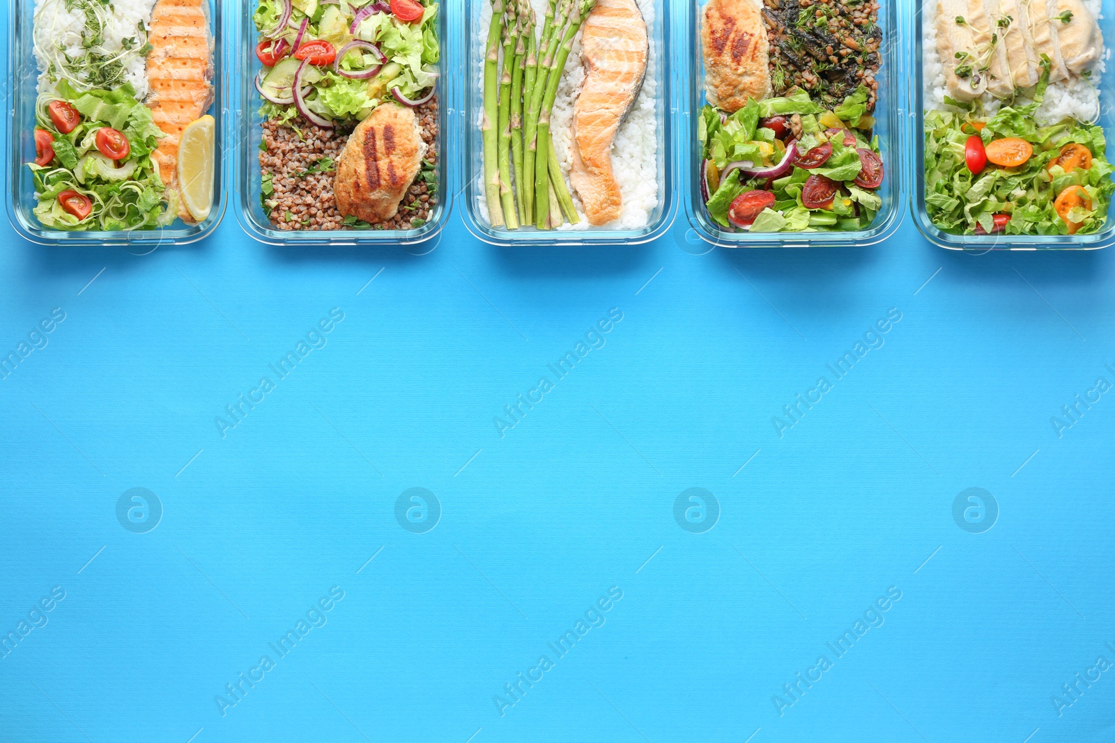 Photo of Healthy food. Different meals in glass containers on light blue background, flat lay. Space for text