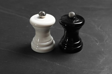 Photo of Salt and pepper shakers on grey textured table