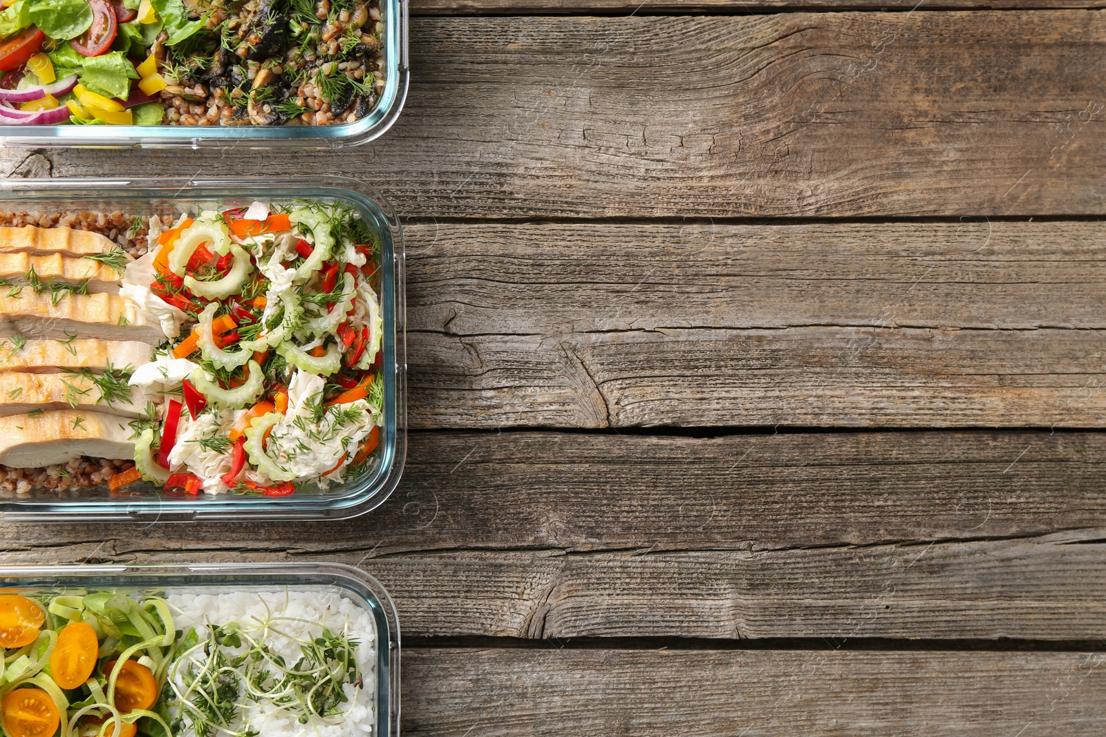 Photo of Healthy meal. Containers with different products on wooden table, flat lay. Space for text