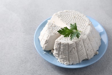 Photo of Tasty ricotta (cream cheese) on grey table, space for text