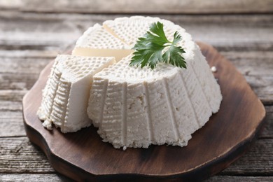 Tasty ricotta (cream cheese) on wooden table, closeup