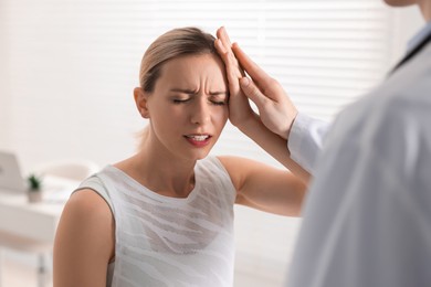 Sports injury. Doctor examining patient in hospital, closeup