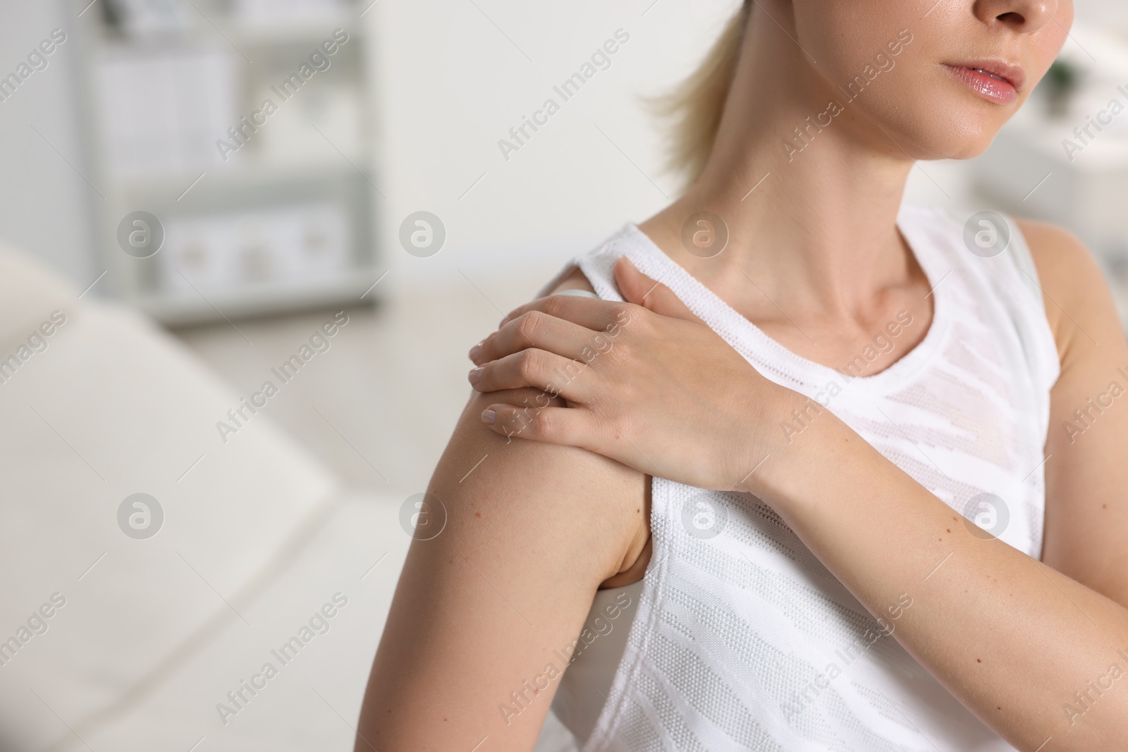 Photo of Sports injury. Woman with pain in shoulder in hospital, closeup