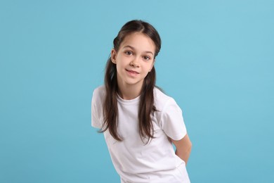 Photo of Portrait of beautiful girl on light blue background