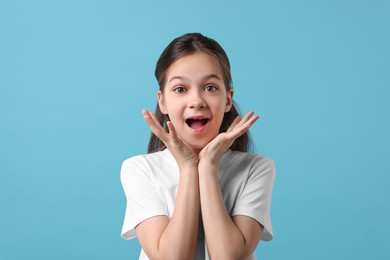 Photo of Portrait of emotional girl on light blue background