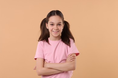 Portrait of beautiful girl on beige background