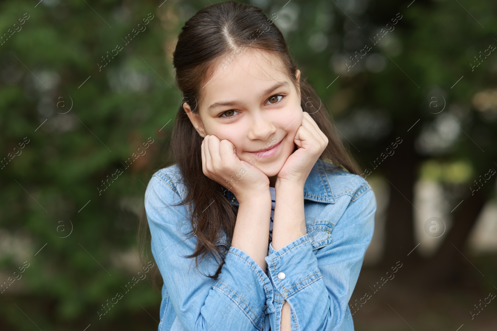 Photo of Portrait of beautiful little girl outdoors. Cute child