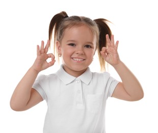 Photo of Portrait of happy little girl showing OK gesture on white background