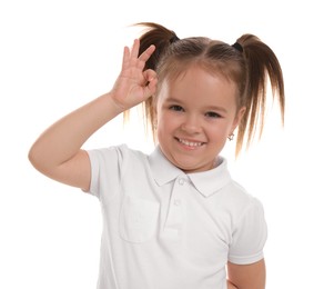 Photo of Portrait of happy little girl showing OK gesture on white background