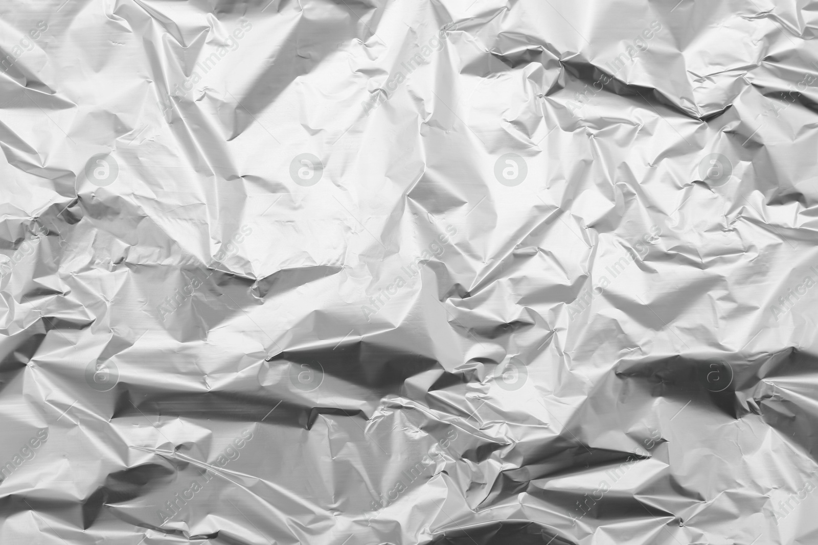 Photo of Crumpled silver foil as background, top view