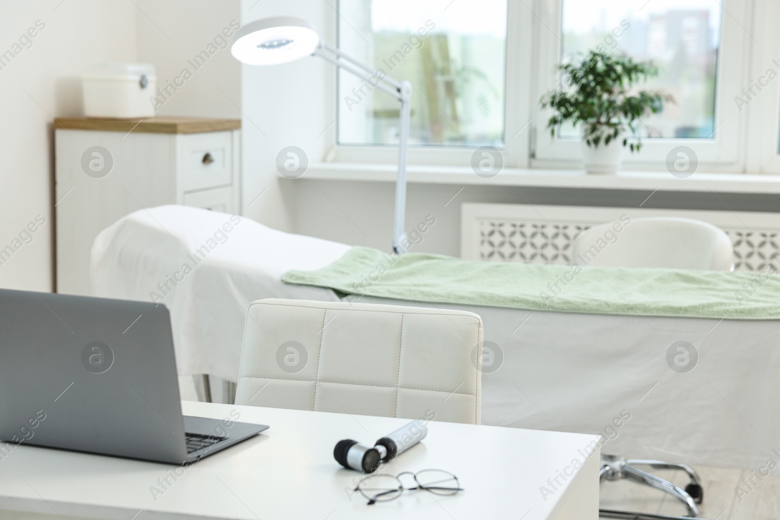 Photo of Modern interior of dermatologist's office with examination table