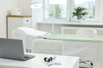 Modern interior of dermatologist's office with examination table