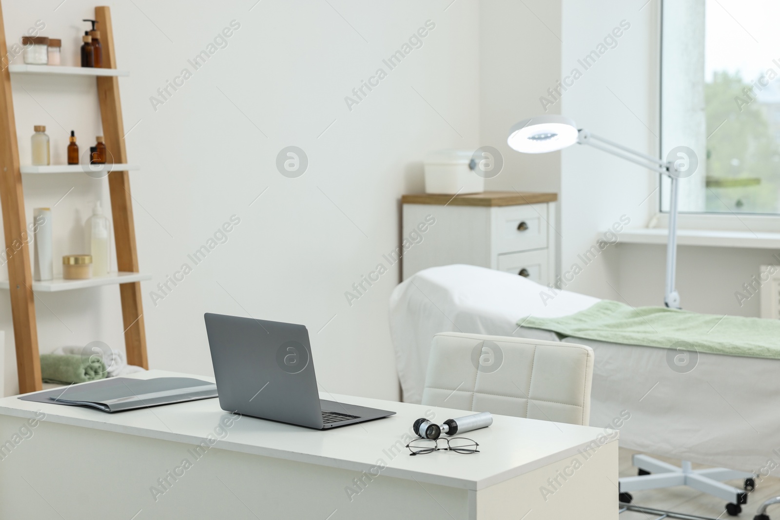 Photo of Modern interior of dermatologist's office with examination table