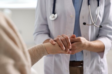 Professional doctor working with patient in hospital, closeup