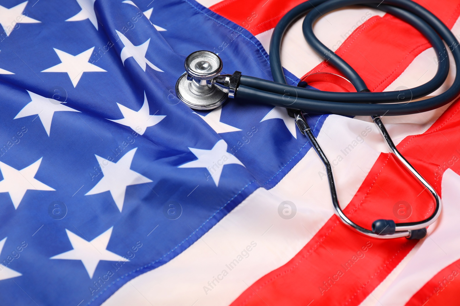 Photo of Stethoscope on USA flag, closeup. Health care concept