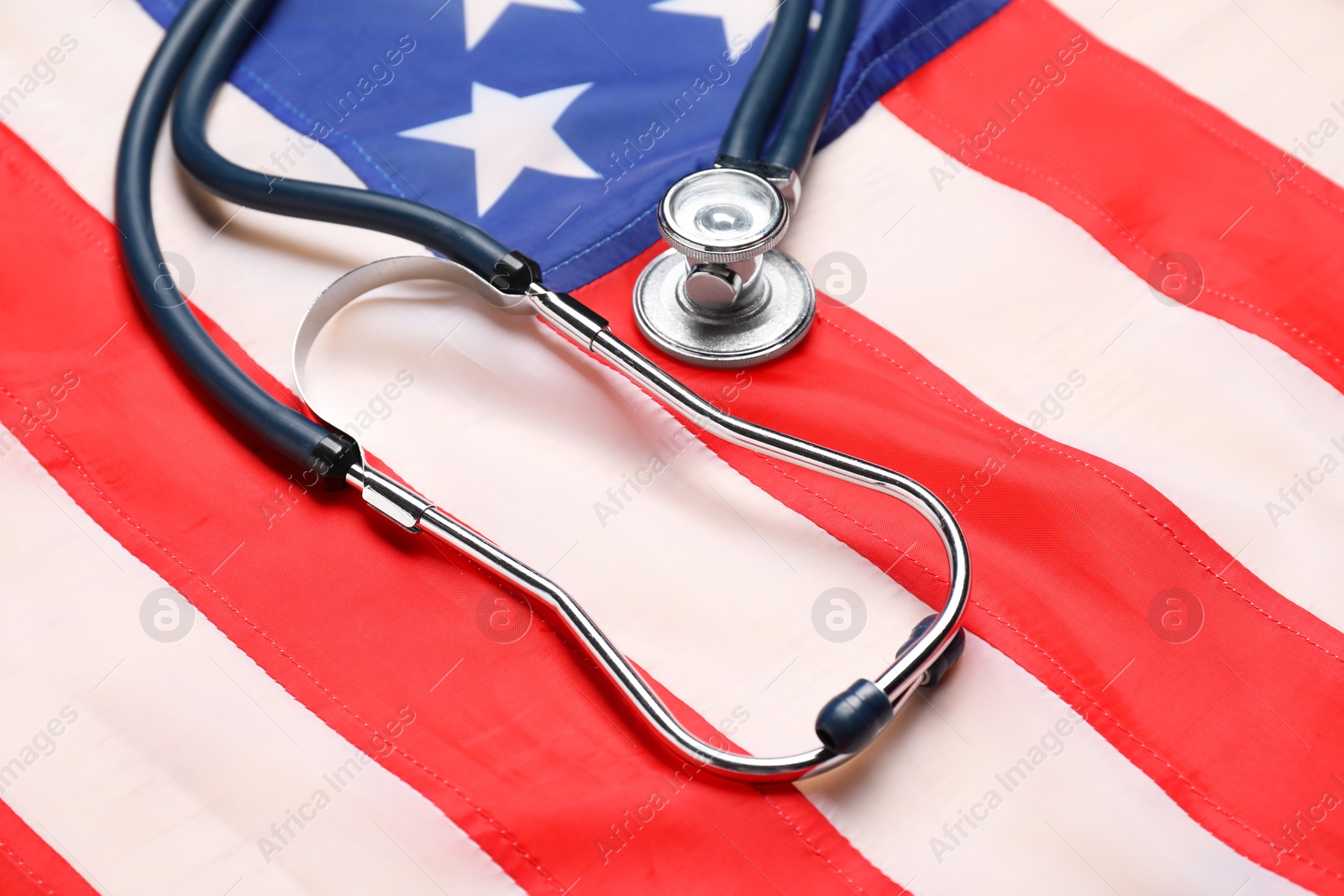 Photo of Stethoscope on USA flag, closeup. Health care concept