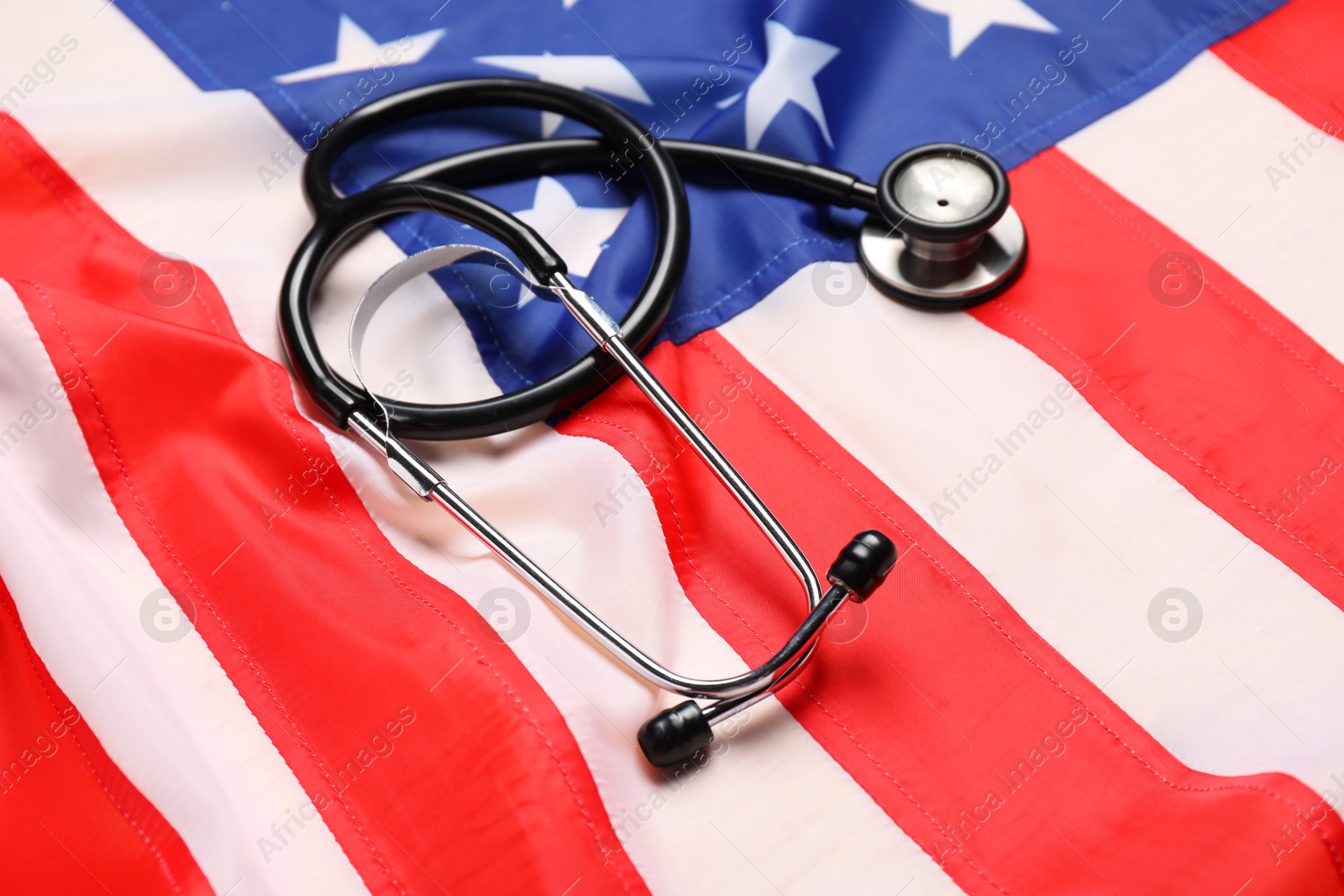 Photo of Stethoscope on USA flag, closeup. Health care concept