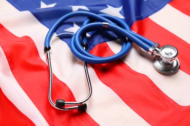 Photo of Stethoscope on USA flag, closeup. Health care concept