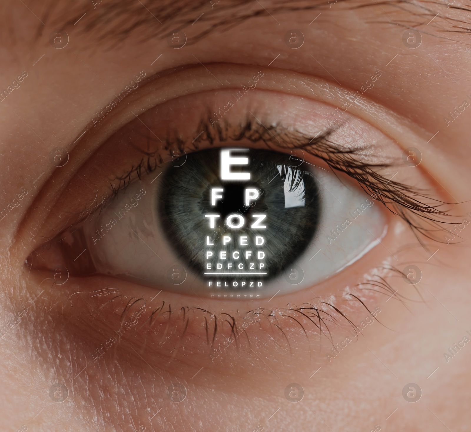 Image of Snellen chart in woman's eye, closeup. Vision acuity test