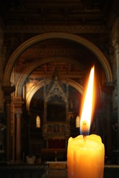 Image of Church candle burning in temple, closeup. Space for text