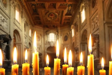 Image of Many church candles burning in temple, closeup