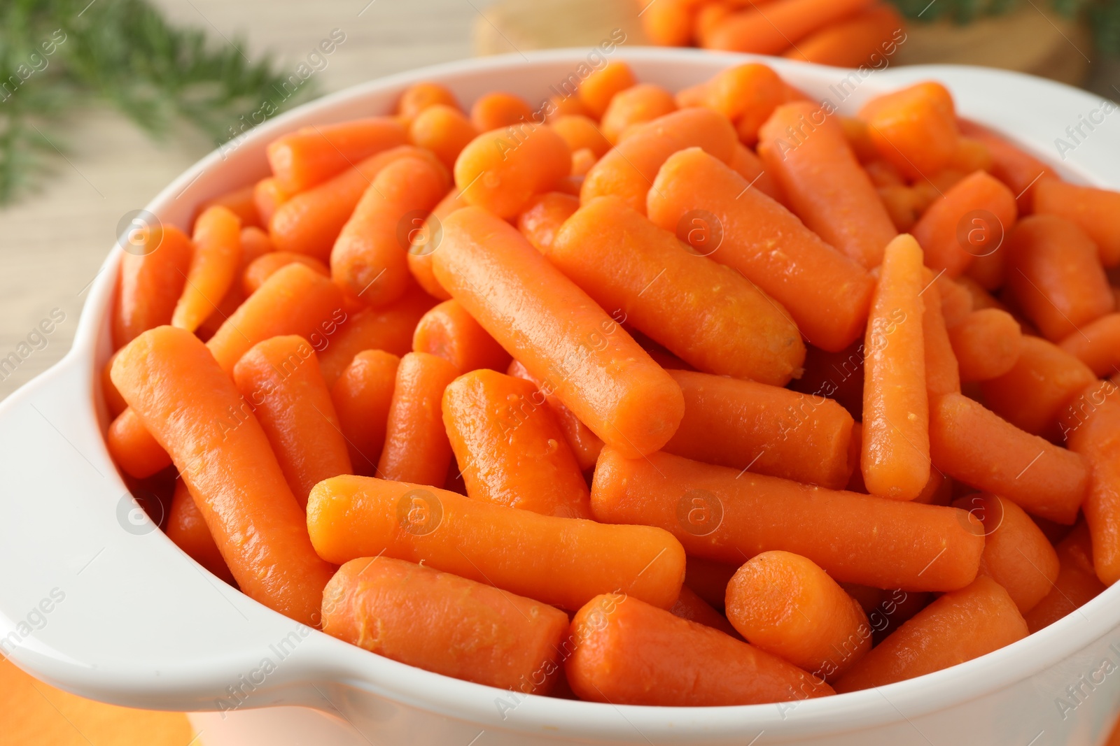 Photo of Baby carrots in pot on table, closeup