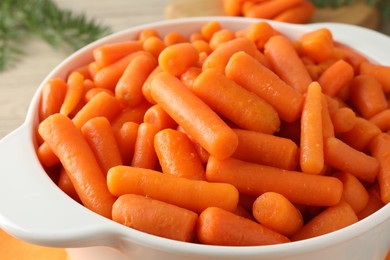 Baby carrots in pot on table, closeup