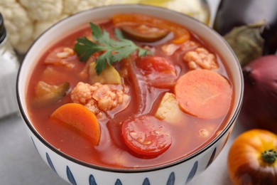 Photo of Tasty homemade stew with vegetables on white table, closeup