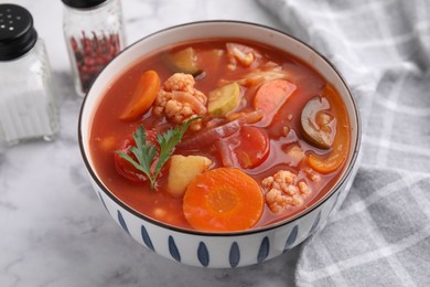 Tasty homemade stew with vegetables on white marble table, closeup