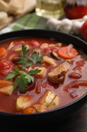 Photo of Tasty homemade stew with vegetables on wooden table, closeup