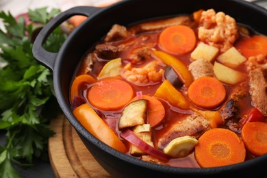 Photo of Tasty homemade stew with vegetables on table, closeup