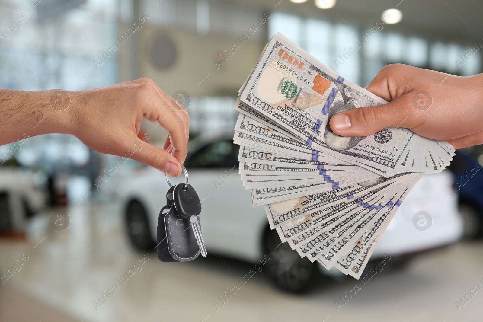 Image of Man giving money to seller in exchange for car key in shop, closeup. Buying auto