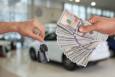 Image of Man giving money to seller in exchange for car key in shop, closeup. Buying auto