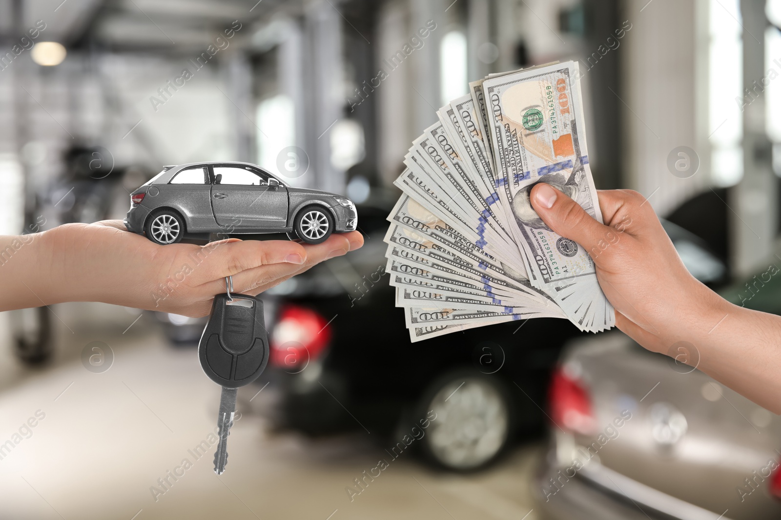 Image of Man giving money to seller in exchange for car key in shop, closeup. Buying auto