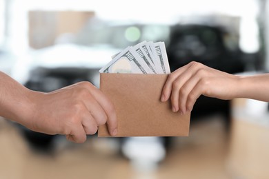 Image of Woman giving money to seller in automotive shop, closeup. Buying car