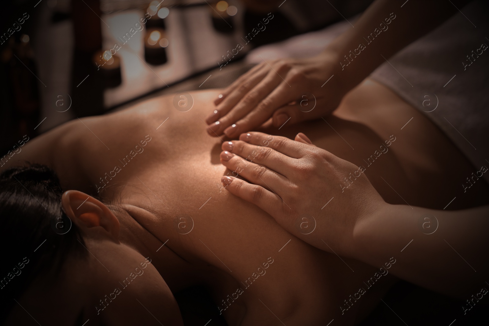 Image of Beautiful young woman lying on table during massage in salon, closeup